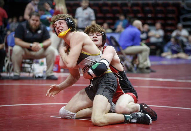 Pekin sophomore Cael Baker, right, fights to keep Emmetsburg senior Spencer Griffin on the mat in their match at 145 pounds during the opening round of Class 1A matches during the Iowa high school state wrestling tournament at Wells Fargo Arena on Thursday, Feb. 14, 2019, in Des Moines.
