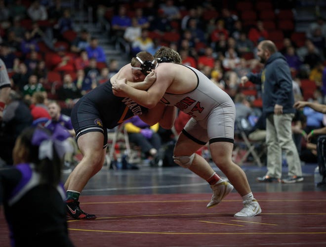 Waukee junior Conner Arndt locks up with Mason City senior Troy Monahan in their match at 285 pounds during the state wrestling quarterfinals on Friday, Feb. 15, 2019, at Wells Fargo Arena in Des Moines.