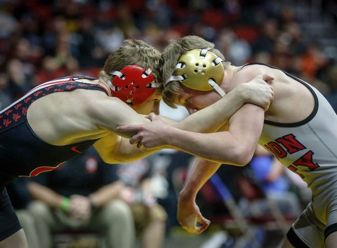 Iowa City High's Ethan Wood-Finley, left, locks up with Mason City's Jace Rhodes in their match at 106 pounds during the state wrestling quarterfinals on Friday, Feb. 15, 2019, at Wells Fargo Arena in Des Moines.
