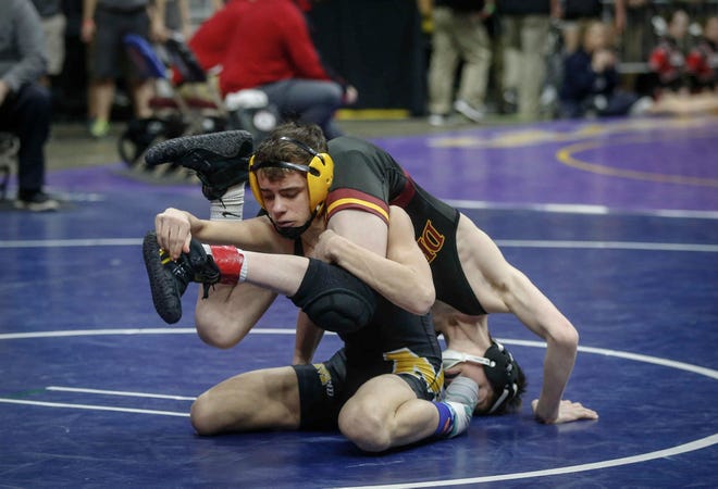 Midland sophomore Damon Huston scores on Denver freshman Joe Ebaugh in their match at 106 pounds during the state wrestling quarterfinals on Friday, Feb. 15, 2019, at Wells Fargo Arena in Des Moines.