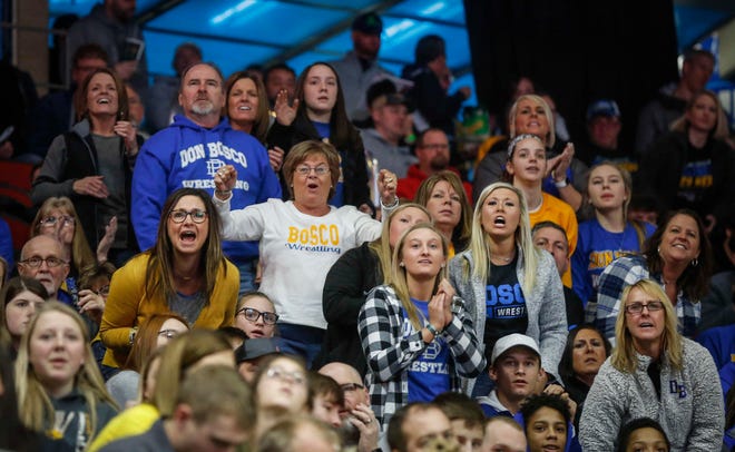 Don Bosco fans cheer during the state wrestling quarterfinals on Friday, Feb. 15, 2019, at Wells Fargo Arena in Des Moines.
