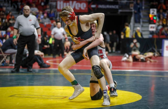 Iowa City High's Ethan Wood-Finley tries to break free from Mason City's Jace Rhodes in their match at 106 pounds during the state wrestling quarterfinals on Friday, Feb. 15, 2019, at Wells Fargo Arena in Des Moines.