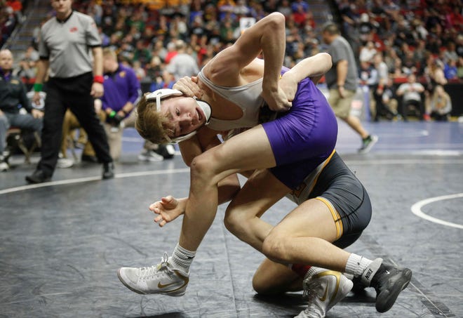 Johnston junior Thomas Edwards works to break free from Southeast Polk freshman Joel Jesuroga at 120 pounds during the state wrestling quarterfinals on Friday, Feb. 15, 2019, at Wells Fargo Arena in Des Moines.