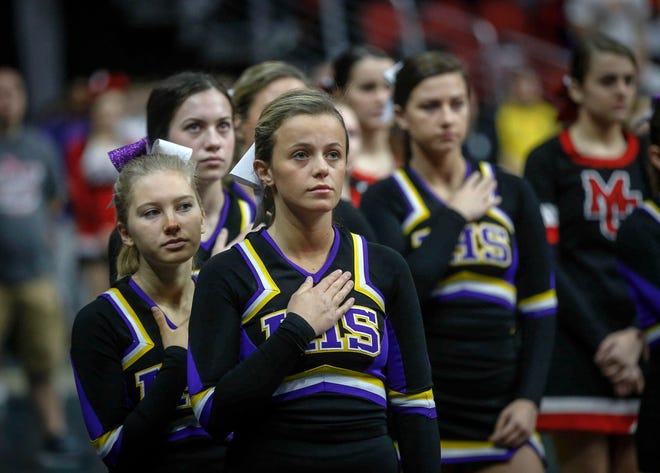 The Indianola cheerleaders observe the National Anthem prior to the start of the state wrestling quarterfinals on Friday, Feb. 15, 2019, at Wells Fargo Arena in Des Moines.