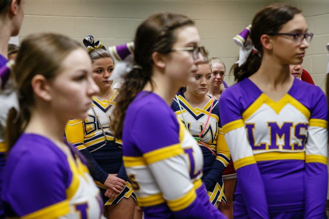 Cheerleaders get instructions on how the day will go before the 1A state championship semi-final round on Friday, Feb. 15, 2019 in Des Moines.