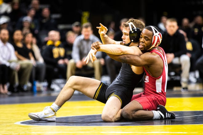 Iowa's Spencer Lee, left, wrestles Indiana's Elijah Oliver at 125 during a NCAA Big Ten Conference wrestling dual on Friday, Feb. 15, 2019 at Carver-Hawkeye Arena in Iowa City, Iowa.