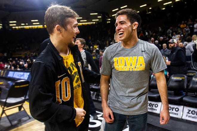 Iowa's Spencer Lee, left, and senior Perez Perez talk after a NCAA Big Ten Conference wrestling dual on Friday, Feb. 15, 2019 at Carver-Hawkeye Arena in Iowa City, Iowa.