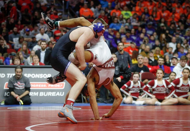 Central Springs senior Zach Ryg takes Mason City Newman Catholic's Chase McCleish to the mat in their match at 195 pounds during the state wrestling Class 1A championship on Saturday, Feb. 16, 2019, at Wells Fargo Arena in Des Moines.