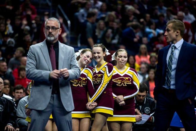 A group of Ankeny cheerleaders wait for the start of the Iowa high school state wrestling championships on Saturday, Feb. 16, 2019, in Wells Fargo Arena.