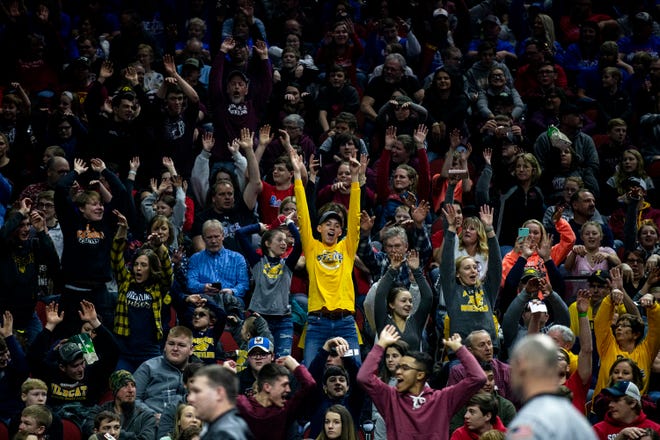 The crowd does the wave the start of the Iowa high school state wrestling championships on Saturday, Feb. 16, 2019, in Wells Fargo Arena.