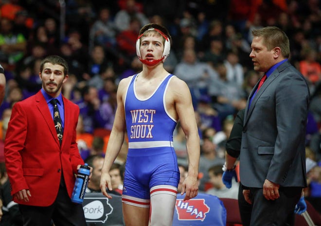 West Sioux senior Kory Van Oort looks over at the fan section during an injury timeout in his match against North Linn senior Brady Henderson at 152 pounds during the state wrestling Class 1A championship on Saturday, Feb. 16, 2019, at Wells Fargo Arena in Des Moines.