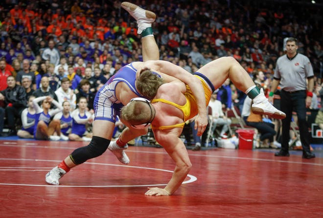 AHSTW senior Gabe Pauley scores an overtime takedown against Don Bosco junior Thomas Even for a Class 1A state championship win at 182 pounds on Saturday, Feb. 16, 2019, at Wells Fargo Arena in Des Moines.