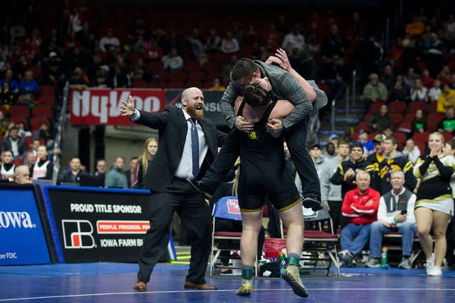 Waverly-Shell Rock's Andrew Snyder hugs his coach Eric Whitcome after winning the 285 pound class 3A championship match against Bettendorf's Griffin Liddle during the Iowa high school state wrestling tournament on Saturday, FEB.16, 2019, in Wells Fargo Arena.