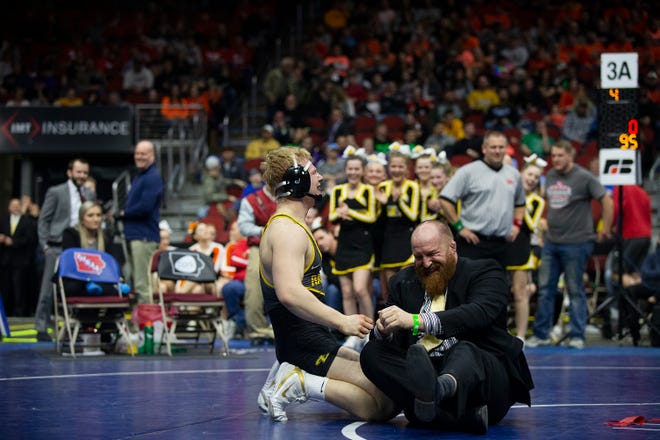 Southeast Polk's Gabe Christenson pulls his coach onto the mat while celebrating his win in the 195 pound class 3A championship match against Waverly-Shell Rock's Brayden Wolf during the Iowa high school state wrestling tournament on Saturday, FEB.16, 2019, in Wells Fargo Arena.