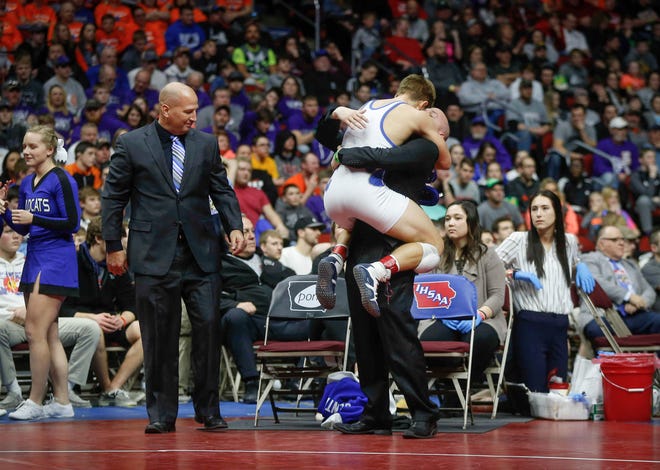 Woodbury Central junior Wade Mitchell celebrates with his coaches after beating Emmetsburg senior Spencer Griffin for a Class 1A state title win at 145 pounds on Saturday, Feb. 16, 2019, at Wells Fargo Arena in Des Moines.