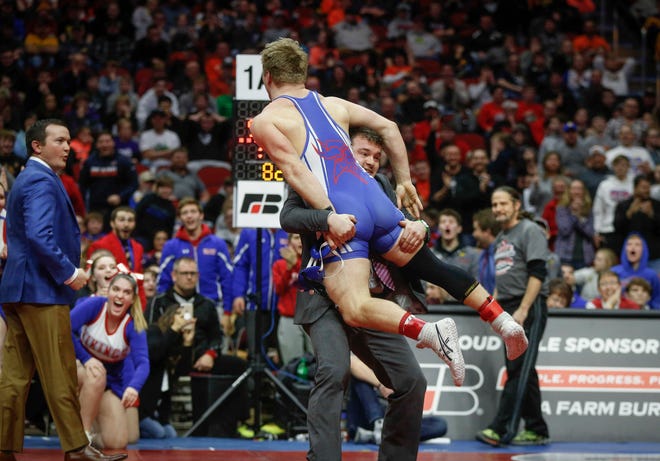 AHSTW senior Gabe Pauley celebrates with his coaches after scoring an overtime win against Don Bosco junior Thomas Even for a Class 1A state championship win at 182 pounds on Saturday, Feb. 16, 2019, at Wells Fargo Arena in Des Moines.