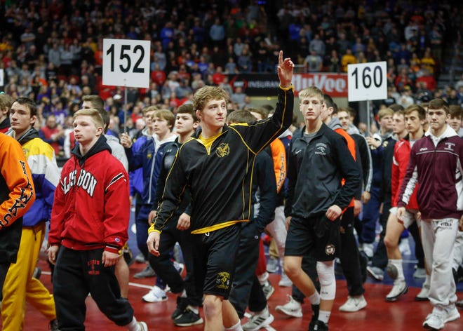 Wrestlers take the mat for the Grand March prior to the start of the 2019 Iowa high school wrestling championship matches on Saturday, Feb. 16, 2019, at Wells Fargo Arena in Des Moines.