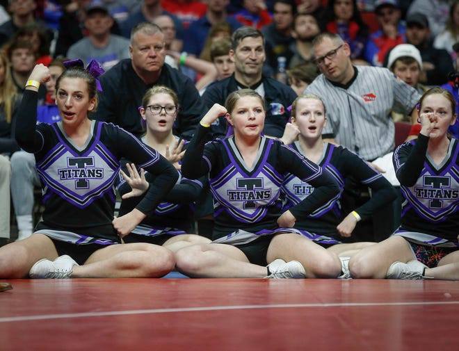 Cheerleaders cheer on their wrestler during the state wrestling Class 1A championship on Saturday, Feb. 16, 2019, at Wells Fargo Arena in Des Moines.