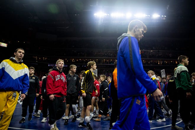 Wrestlers parade through Wells Fargo Arena before the start of the Iowa high school state wrestling championships on Saturday, Feb. 16, 2019, in Des Moines.