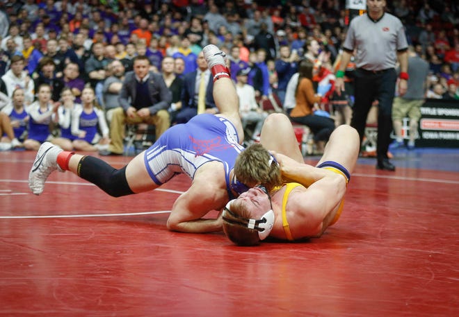 AHSTW senior Gabe Pauley scores an overtime takedown against Don Bosco junior Thomas Even for a Class 1A state championship win at 182 pounds on Saturday, Feb. 16, 2019, at Wells Fargo Arena in Des Moines.
