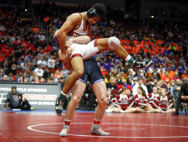 Central Springs senior Zach Ryg takes Mason City Newman Catholic's Chase McCleish to the mat in their match at 195 pounds during the state wrestling Class 1A championship on Saturday, Feb. 16, 2019, at Wells Fargo Arena in Des Moines.