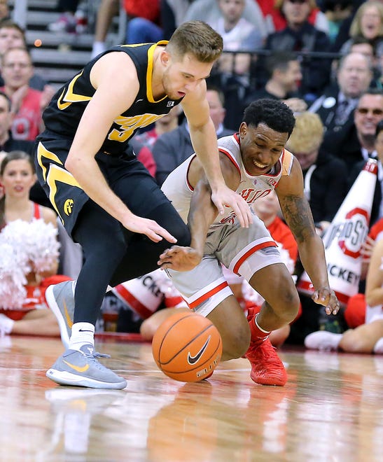 Feb 26, 2019; Columbus, OH, USA; Iowa Hawkeyes guard Jordan Bohannon (3) and Ohio State Buckeyes guard C.J. Jackson (3) dive for a loose ball during the first half at Value City Arena.