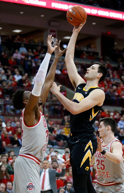 Iowa forward Ryan Kriener, right, goes up for a shot against Ohio State forward Andre Wesson during the first half of an NCAA college basketball game in Columbus, Ohio, Tuesday, Feb. 26, 2019.