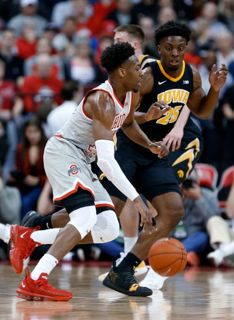 Ohio State forward Andre Wesson, left, drives against Iowa forward Tyler Cook during the first half of an NCAA college basketball game in Columbus, Ohio, Tuesday, Feb. 26, 2019.