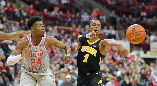 Feb 26, 2019; Columbus, OH, USA; Iowa Hawkeyes guard Maishe Dailey (1) passes by Ohio State Buckeyes forward Andre Wesson (24) during the second half at Value City Arena.
