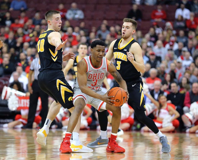 Feb 26, 2019; Columbus, OH, USA; Ohio State Buckeyes guard C.J. Jackson (3) is guarded by Iowa Hawkeyes guard Joe Wieskamp (10) and Iowa Hawkeyes guard Jordan Bohannon (3) during the second half at Value City Arena.