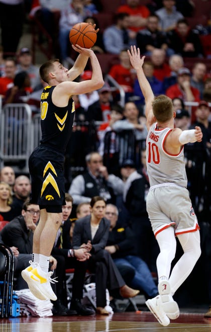 Iowa guard Joe Wieskamp, left, goes up for a shot against Ohio State forward Justin Ahrens during the second half of an NCAA college basketball game in Columbus, Ohio, Tuesday, Feb. 26, 2019. Ohio State won 90-70.