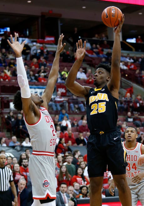 Iowa forward Tyler Cook, right, goes up for a shot against Ohio State forward Andre Wesson during the first half of an NCAA college basketball game in Columbus, Ohio, Tuesday, Feb. 26, 2019.