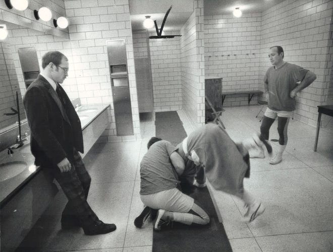 From 1976: Under the watchful eye of coach Dan Gable, left, members of his alumni team work on some moves before a wrestling meet at Iowa State University. On the floor are Gary Wallman, in robe, an all-American in 1967-68, and Dale Bahr, a 1968 national champion and current Iowa State assistant coach. At right is Dean Corner, 40, a Big Eight champion in 1956.
