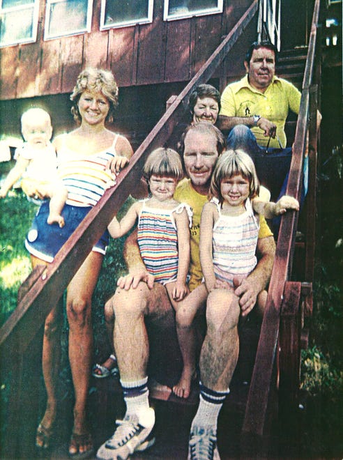 From 1983: Iowa wrestling coach Dan Gable off the mat, with family at their cabin near Lansing, Iowa. Gable is pictured with daughters Jennie and Annie, wife Kathy stands with daughter Molly. Gable's parents, Mack and Katie, are in back.