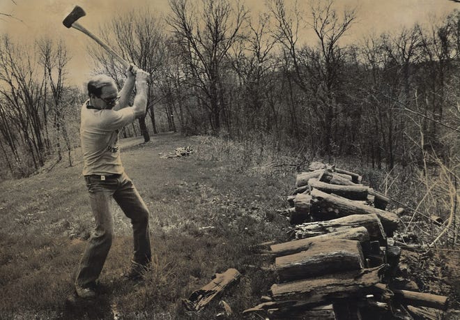 From 1983: Dan Gable chops wood on land north of Iowa City where he planned to build a new home.