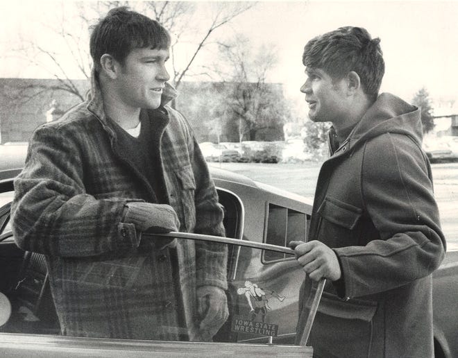 From 1970: Iowa State student-athlete Dan Gable, left, talks to Cyclones wrestling teammate Doug Moses, of Waterloo, before driving off in his Mustang.