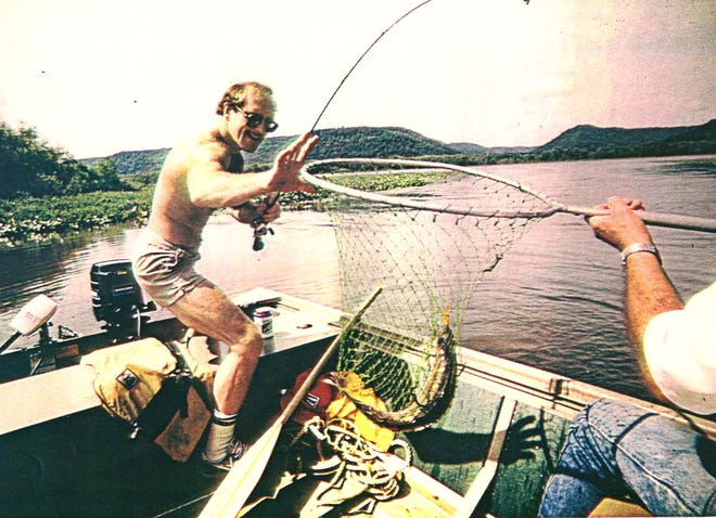 From 1983: Iowa wrestling coach Dan Gable nets a 5-pound walleye caught on the Mississippi River near his home in Lansing.