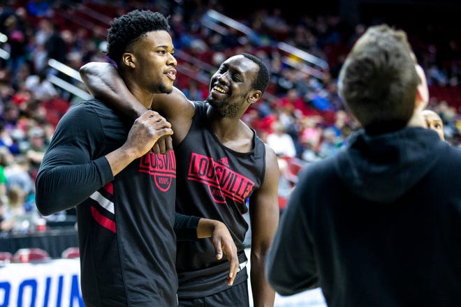 Louisville's Akoy Agau and Steven Enoch laugh between practice drills during Louisville's open practice before the first round of the NCAA Men's Basketball Tournament on Wednesday, March 20, 2019, at Wells Fargo Arena in Des Moines, Iowa.