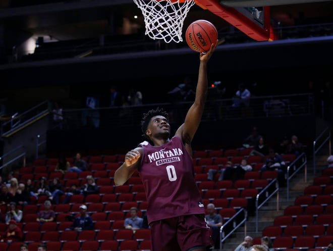 Montana senior Michael Oguine runs the ball up to the net during open practice on Wednesday, March 20, 2019, at Wells Fargo Arena in Des Moines, Iowa.
