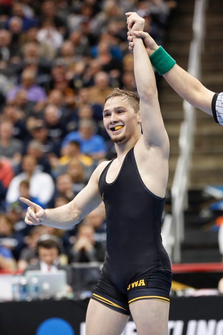 Iowa's Spencer Lee celebrates defeating Oklahoma State's Nicholas Piccinni in their 125-pound match in the semifinals of the NCAA wrestling championships, Friday, March 22, 2019, in Pittsburgh. Lee faces Virginia's Jack Mueller for the championship Saturday.