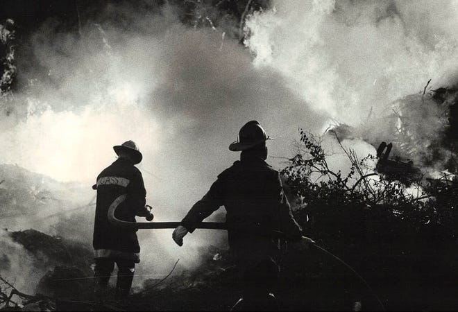 From 1977: Des Moines firefighters work to control a brush fire on state land south of Court Avenue near E. 12th Street. Flames shot 40 feet into the air, according to spectators.
