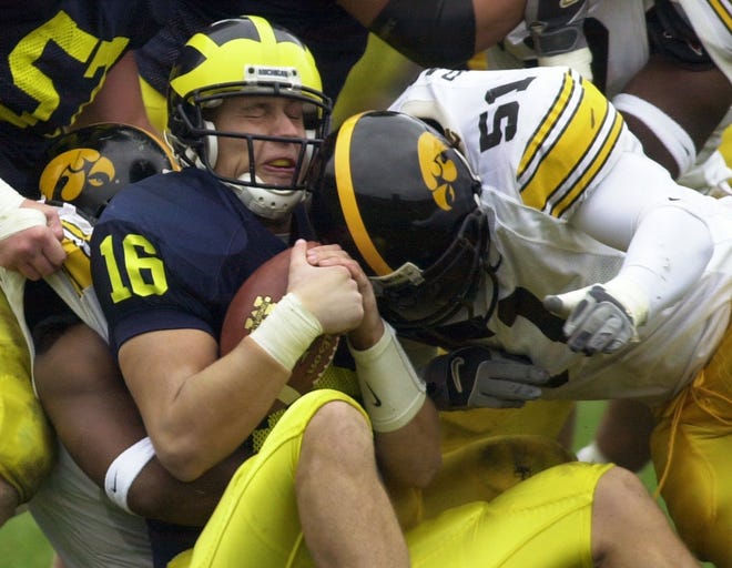 Fred Barr sacks Michigan quarterback John Navarre in the second quarter of a game played Oct. 26, 2002 in Ann Arbor, Michigan. The Hawkeyes won the game 34-9.