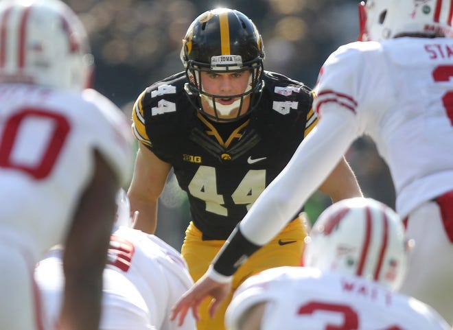 Iowa middle linebacker James Morris eyes the offense during the Hawkeyes game against Wisconsin at Kinnick Stadium on Nov. 2, 2013.