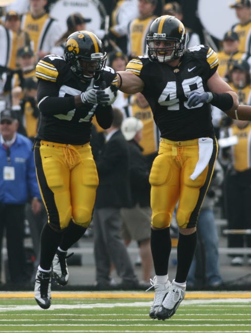 Iowa linebacker Bruce Davis (57) celebrates with teammate A.J. Edds after he recovered a fumble against Minnesota on Nov. 21, 2009 at Kinnick Stadium.