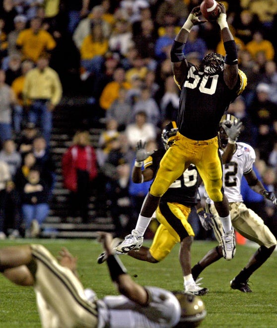 George Lewis leaps high to intercept pass thrown by Purdue quarterback Brandon Kirsch late in fourth quarter of a Nov. 6, 2004 game played in Iowa City.