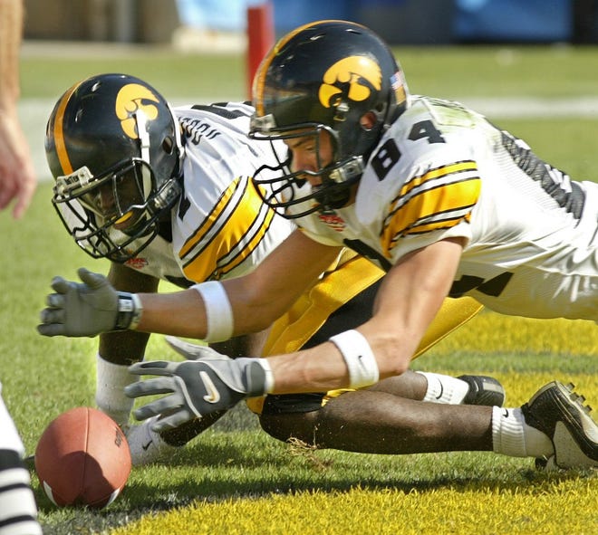 Iowa linebacker Jermine Roberts (left) and Matt Melloy recover the ball in the endzone for a touchdown after a punt was blocked against Florida in the Outback Bowl on Jan. 1, 2004 in Tampa, Florida.