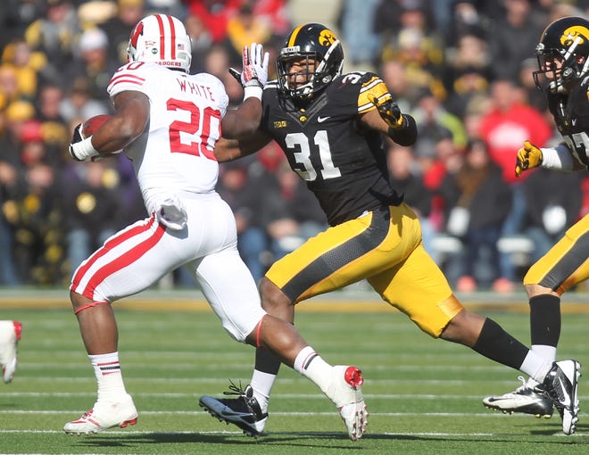 Anthony Hitchens pursues Wisconsin running back James White during Iowa's game against the Badgers on Nov. 2, 2013 at Kinnick Stadium.