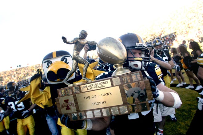 Iowa linebacker Tyler Nielsen carries the Cy-Hawk trophy after defeating Iowa State 35-7 on Sept. 11, 2010 in Iowa City.
