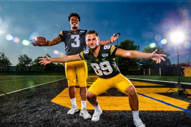 Tyrone Tracy, Jr. and Nico	Ragaini stand for a photo during Hawkeye football media day Friday, Aug. 9, 2019.