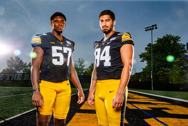 Chauncey	Golston and A.J. Epenesa stand for a photo during Hawkeye football media day Friday, Aug. 9, 2019.